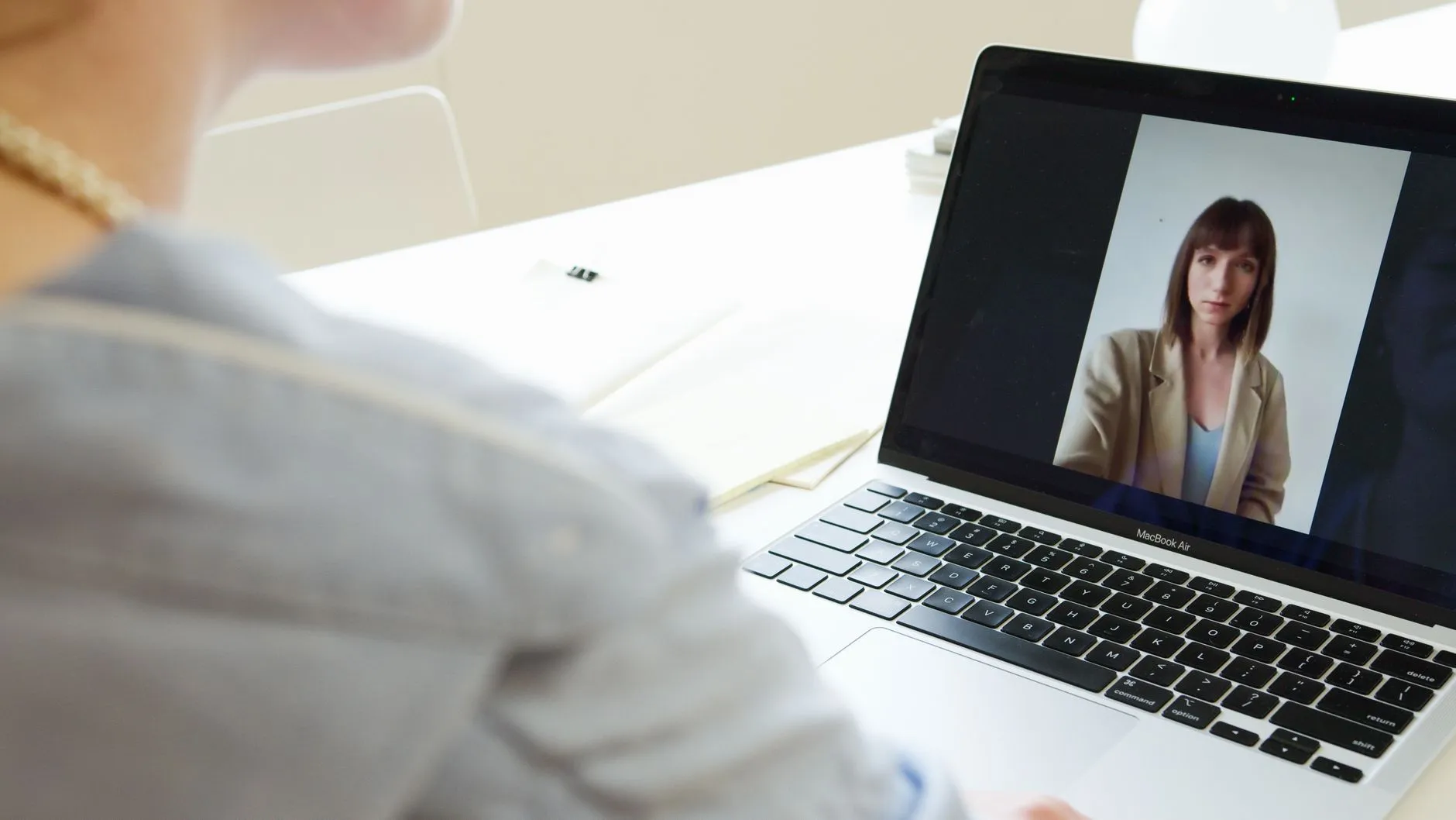 Psicóloga en una videollamada de terapia en línea desde su laptop.